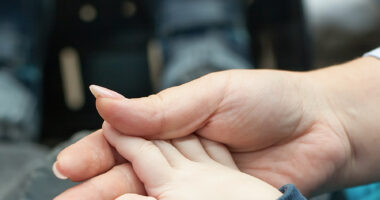 juvenile idiopathic arthritis/fabrydiseasenews.com/adult holding child's hand image