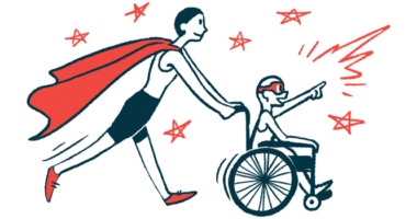 An adult wearing a superhero cape pushes the wheelchair of a child wearing an eye mask.