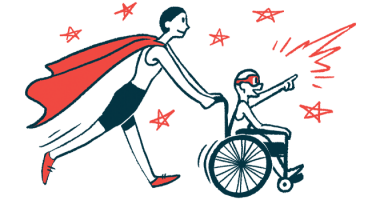 An adult wearing a superhero cape pushes the wheelchair of a child wearing an eye mask.