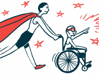 An adult wearing a superhero cape pushes the wheelchair of a child wearing an eye mask.