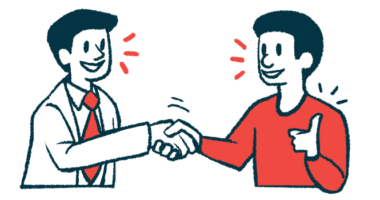 A patient gives a thumbs-up sign while shaking hands with a doctor.