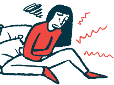 A woman sitting on the floor is clutching her stomach in pain.