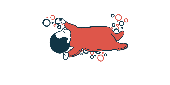 An infant in a red onesie naps with arms and legs outstretched.